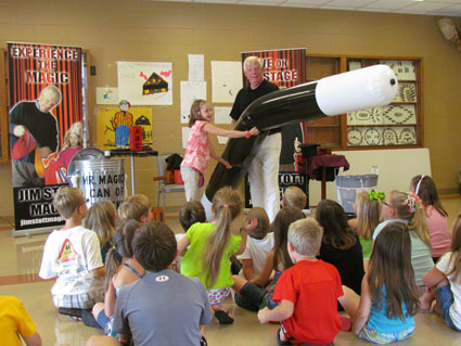 Magician Jim Stott sawing a volunteer in half